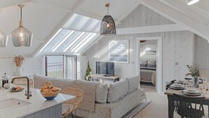 A modern loft with a kitchen, dining area, and living space. - 3 Bed in Bridgend (oc-86494) (Southerndown)
