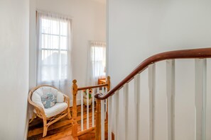A staircase with a wooden handrail leading to a landing.