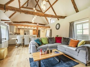 A cozy living room with a sofa, a coffee table, and a dining area with chairs. - 3 Bed in Norwich (oc-86387) (Sloley)