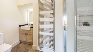 A bathroom with a toilet, sink, mirror, and a towel rack. - 2 Bed in Mindrum (oc-86637) (Carham)