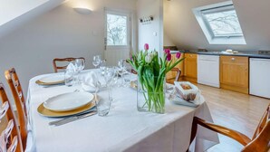 A dining area with a table set for four, a kitchen in the background, and a skylight. - 1 Bed in Cranbrook (oc-87119) (Benenden)