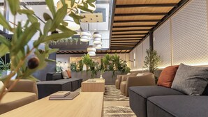 A modern interior with a sofa, coffee table, and hanging plants.