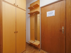A wooden wardrobe with a mirror and a door with a lock. - One Bedroom Apartment with Balcony (Malinska)