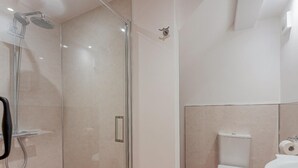 A modern bathroom with a glass-enclosed shower, a toilet, and a sink. - 4 Bed in Church Stretton (oc-87695) (Gretton)