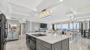 A modern kitchen with a large island, built-in appliances, and a view to the outside. - 22nd-Floor Oceanfront Luxury · Maisons Sur-Mer (Myrtle Beach)