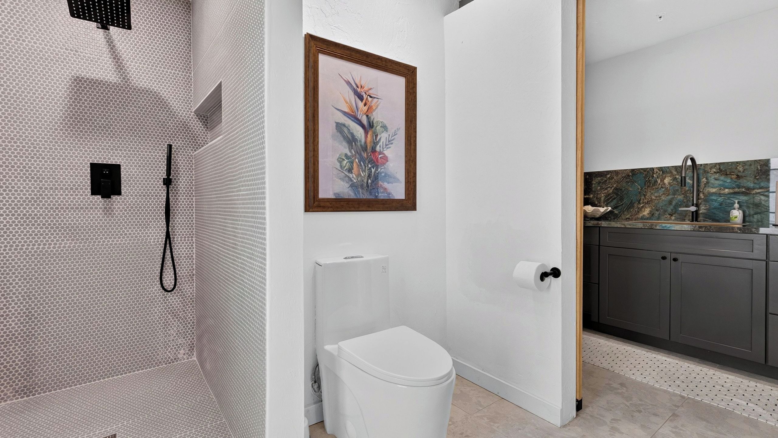 A bathroom with a shower, toilet, and sink.
