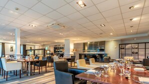 A hotel dining area with multiple tables, chairs, and a bar. - 2 Bed in Saltash (oc-87706) (Saint Mellion)