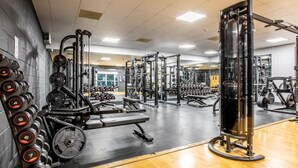 A gym with weightlifting equipment, a bench, and a mirror. - 3 Bed in Saltash (oc-87711) (Saint Mellion)