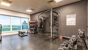 A gym with a pull-up bar, kettlebells, and a weight rack. - 2 Bed in Saltash (oc-87705) (Saint Mellion)