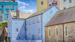 Un edificio costiero con facciata in pietra e esterno blu.