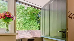 Una habitación con ventana, puerta y radiador.