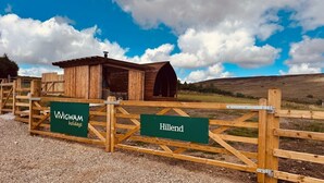 A wooden gate with signs for Wigwam Holidays and Hillend.