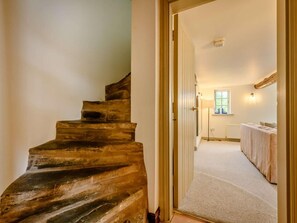 A staircase leading to a room with a bed, a window, and a lamp. - 3 Bed in Cockermouth (oc-88773) (Buttermere)