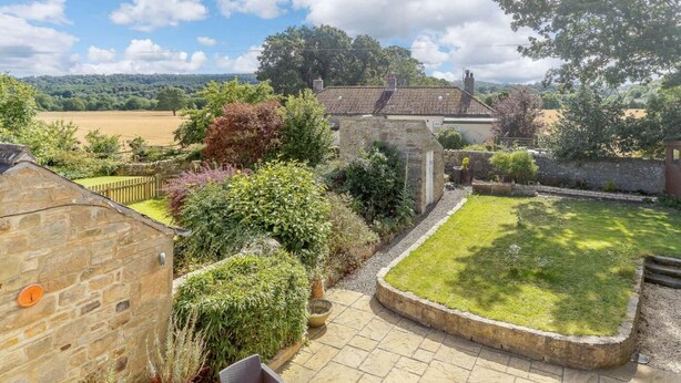 A stone building with a garden, a lawn, and a view of the countryside. - 2 Bed in Hexham (oc-88443) (Acomb)