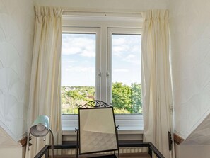 A room with a window, curtains, a metal-framed easel, and a lamp. - 4 Bed in Haverfordwest (oc-88331) (Saint Ishmael's)
