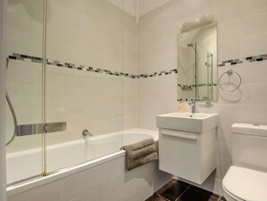 A modern bathroom with a glass-enclosed shower, a white sink, and a toilet. - 7 Bed in King's Lynn (oc-88492) (Snettisham)