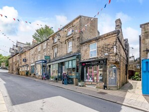 A street with buildings, including a shop with a sign for 'Kendall's Farm Butchers' and another for 'Beauty Boutique'. - 1 Bed in Harrogate (oc-88520) (Pateley Bridge)
