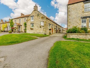 A stone building with a paved driveway and a grassy lawn. - 3 Bed in Pickering (oc-88958) (Newton-on-Rawcliffe)