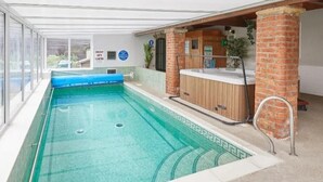 An indoor swimming pool with a hot tub, clear water, and a view of the outside. - 2 Bed in Pickering (oc-88957) (Newton-on-Rawcliffe)