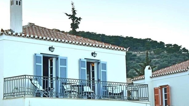 A two-story building with balconies, a chimney, and a tree in the background. - Casa di Spetses - Luxury villa accommodation (Spetses)