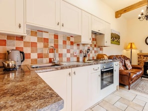 A kitchen with white cabinets, a granite countertop, a stove, and a sink. - 1 Bed in Shrewsbury (oc-89144) (Leighton)