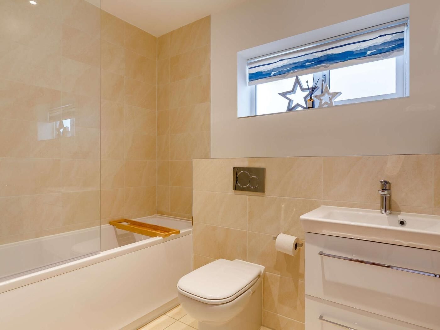 A bathroom with a bathtub, toilet, and sink.