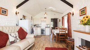 Ein gemütliches Wohnzimmer mit einer Couch, einem Esstisch und einem Kamin.