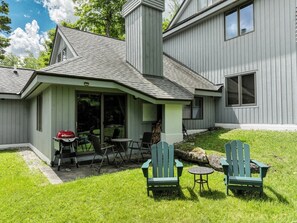 A house with a covered patio, outdoor seating, and a grill. - Pool, Hot Tub, Spa & Ski Shuttle (Killington)