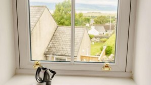 A window with a view of houses and a landscape. - 5 Bed in Askam-in-furness (oc-89226) (Kirkby Ireleth)