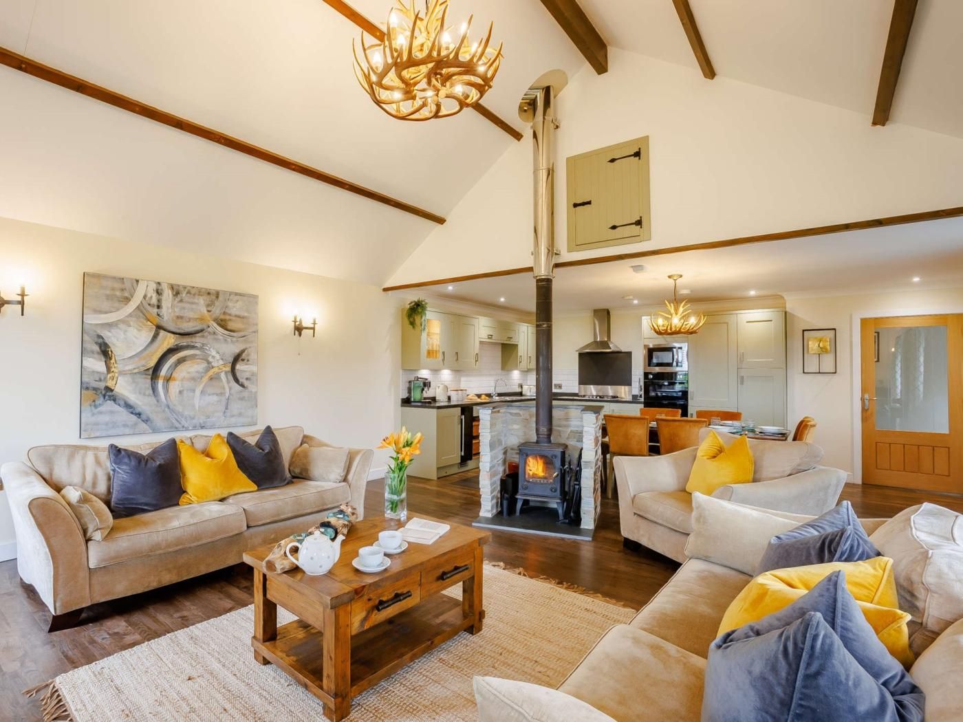 A spacious living area with a fireplace, sofas, and a coffee table.