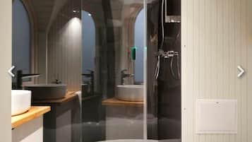 A modern bathroom with a glass-enclosed shower, a sink, and a toilet.