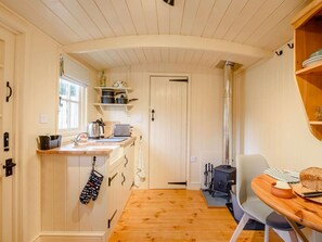 A compact kitchen with wooden cabinets, a sink, and a stove. - 1 Bed in Ashbourne (oc-90021) (Alsop en le Dale)
