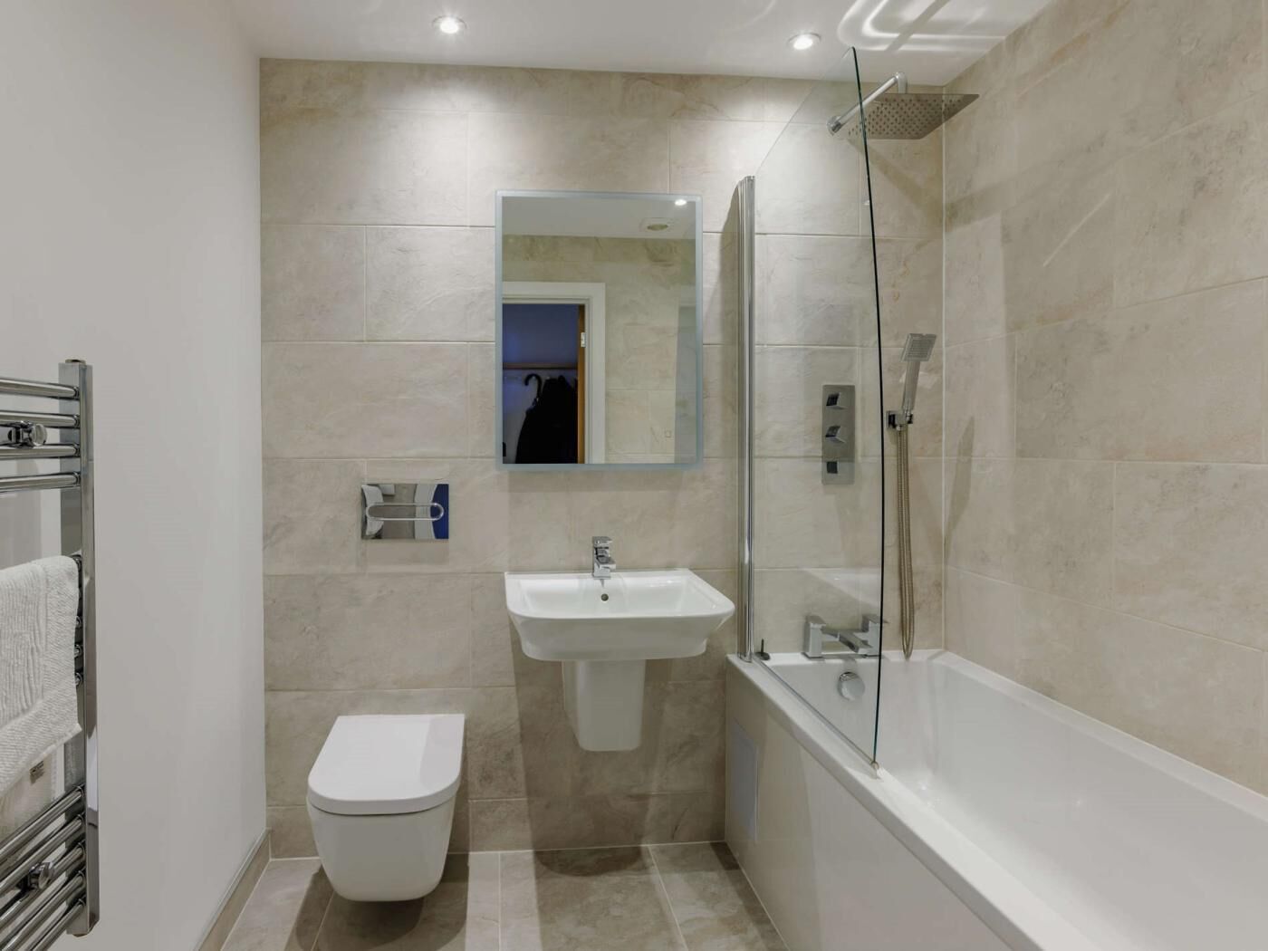 Une salle de bain moderne équipée de toilettes, d’un lavabo et d’une douche.
