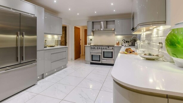 A modern kitchen with stainless steel appliances, a marble floor, and a white countertop. - 4 Bed in Norwich (oc-90094) (Stratton Strawless)