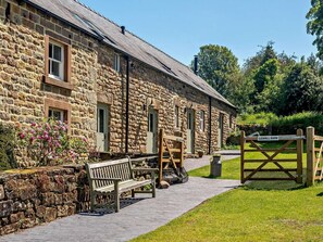 A stone building with a wooden bench and a gate labeled 'LEAHILL BARN.' - 2 Bed in Matlock (oc-89985) (Lea)