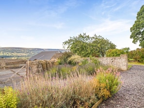 A stone wall, a wooden gate, and a garden with various plants and flowers. - 5 Bed in Crickhowell (oc-90053) (Glangrwyney)