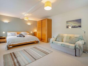 A bedroom with a bed, a sofa, a wardrobe, and a painting on the wall. - 2 Bed in Keswick (oc-89257) (Keswick)