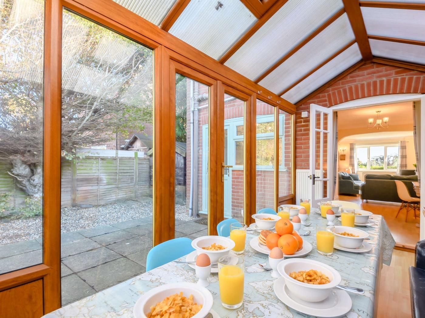 A breakfast setup in a sunlit room with a view of the garden.