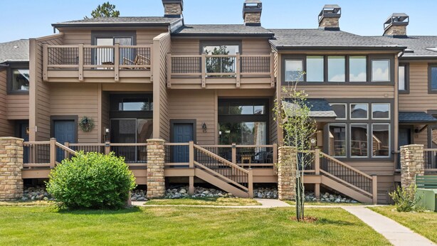 A multi-story residential building with balconies, a covered porch, and a stone foundation. - Cedars Retreat - Walk to Main St & Trails & Pool (Breckenridge)