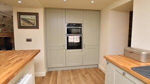 A kitchen with two ovens, a built-in microwave, and a refrigerator. - 3 Bed in Leyburn (oc-89746) (Spennithorne)