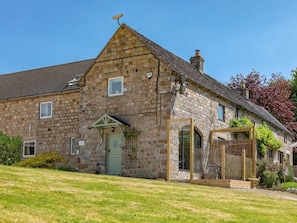 A stone building with a green door, a small porch, and a fenced outdoor area. - 1 Bed in Stoke-on-trent (oc-89733) (Waterhouses)
