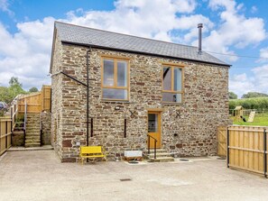A stone building with a wooden door, two windows, and a chimney. - 2 Bed in Bideford (oc-89336) (Monkleigh)