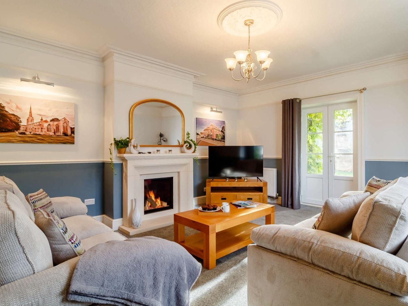 A living room with a fireplace, a television, and a sofa.