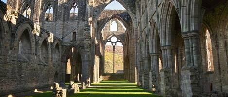 An interior of a historic building with arched ceilings and stone walls.