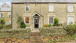 A stone building with a black door, multiple windows, and a stone staircase leading to the entrance. - 2 Bed in Richmond (oc-90435) (Richmond)