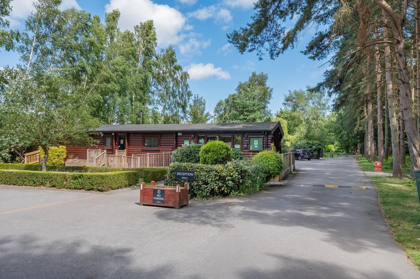 A lodge with a reception area, a no parking sign, and a paved driveway.