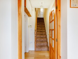 A staircase leading to an upper floor with a wooden handrail and a light fixture above. - 3 Bed in Corwen (oc-90459) (Corwen)
