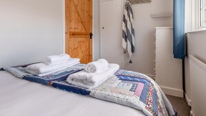 A bedroom with a bed, a wooden door, a radiator, and a wall-mounted towel rack. - 3 Bed in Belford (oc-90351) (Belford)