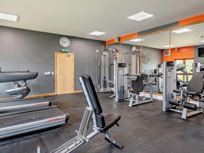 A gym with treadmills, weight machines, and a mirror wall. - 1 Bed in Penrith (oc-90300) (Hutton)