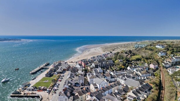 A coastal town with a marina, residential buildings, and a beach. - 5 Bed in Aberdovey (oc-90493) (Aberdovey)